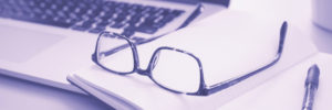 Pair of glasses on a note pad.