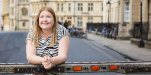 Hannah leaning on wall on an Oxford street.