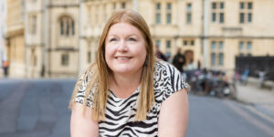 Hannah leaning on wall on an Oxford street.