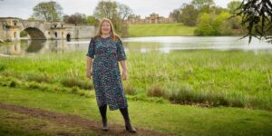 Hannah stood near bridge over lake.