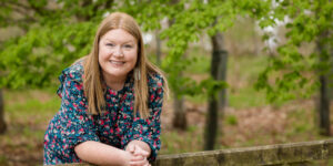 Hannah leaning on fence.