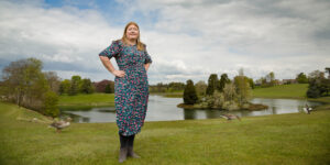 Hannah stood in front of lake island.