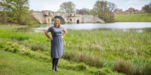 Hannah in front of bridge by the lake.