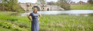 Hannah in front of lake and bridge