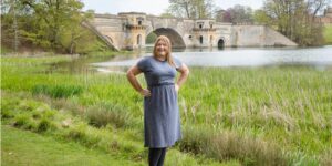 Hannah in front of bridge by the lake.