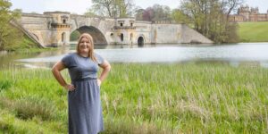 Hannah in front of lake and bridge