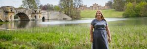 Hannah in front of lake and bridge