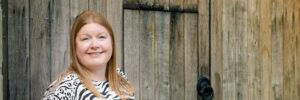 Hannah in front of old wooden door