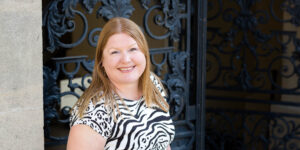 Hannah in front of fancy iron gate