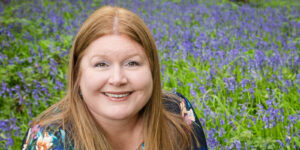 Hannah knelt down in bluebell woods.