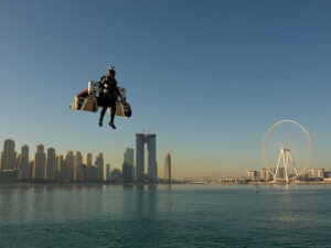 Man flying with jet pack over water